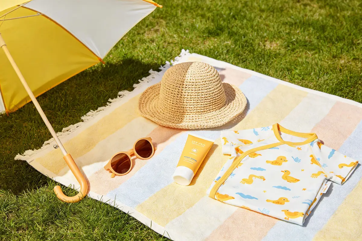 Baby sun safety essentials: sunscreen, hat, UV clothing, sunglasses