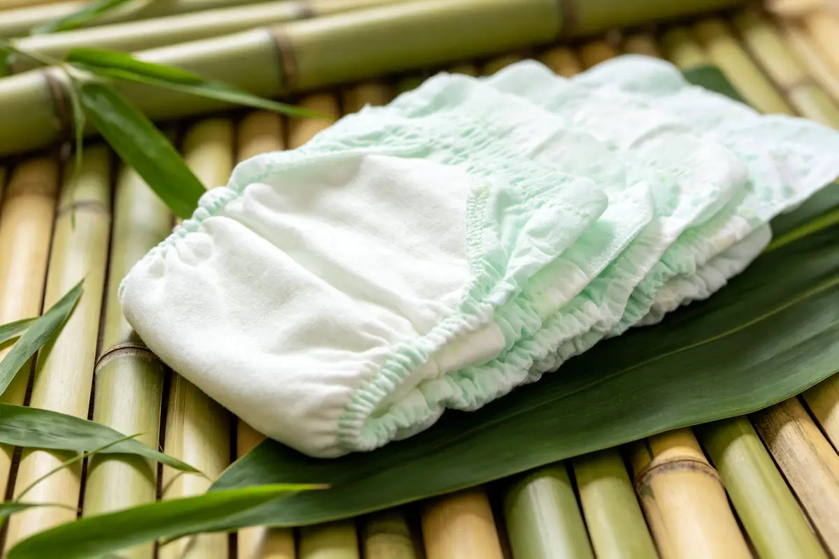 Organic eco-friendly baby diapers with green leaves and natural bamboo