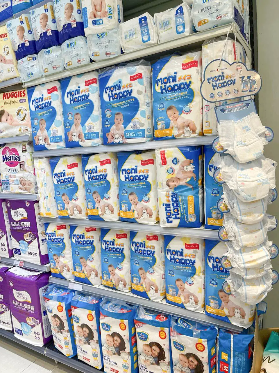 Fully stocked Moni Happy diaper display in a Cambodian maternity and baby store